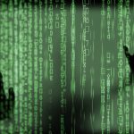 Shadow hands against screen filled with code representing pitfalls to avoid in bespoke software development