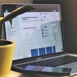 Plant in front of laptop and smartphone representing computing using cloud software