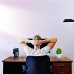 Man sitting at desk working remotely