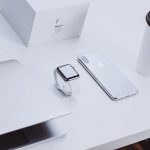 Apple laptop Apple watch Apple iPhone coffee mug on white desk