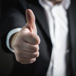 Thumbs up hand held out in front businessman