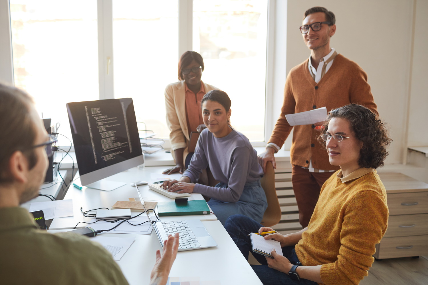 BSPOKE Software - Group of people discussing outsourcing or outstaffing their company's software development project