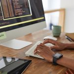 BSPOKE Software - Software developer coding on a laptop representing purchasing a custom software system for a business
