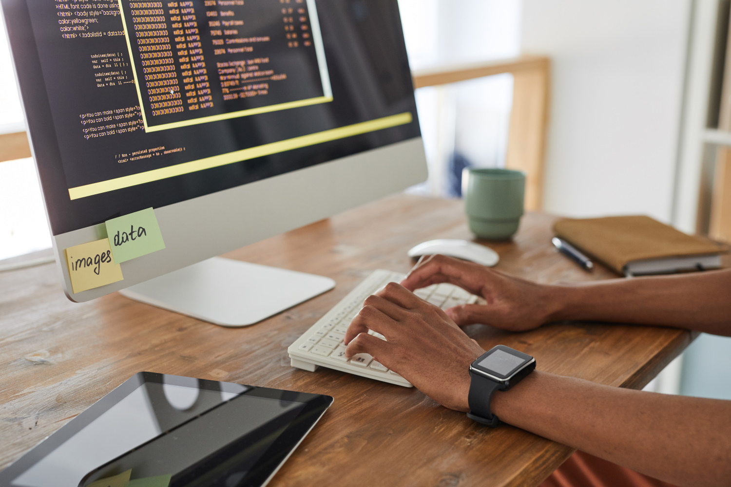 BSPOKE Software - Software developer coding on a laptop representing purchasing a custom software system for a business