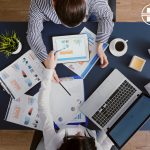 Manager arround table discussing financial invoicing custom software