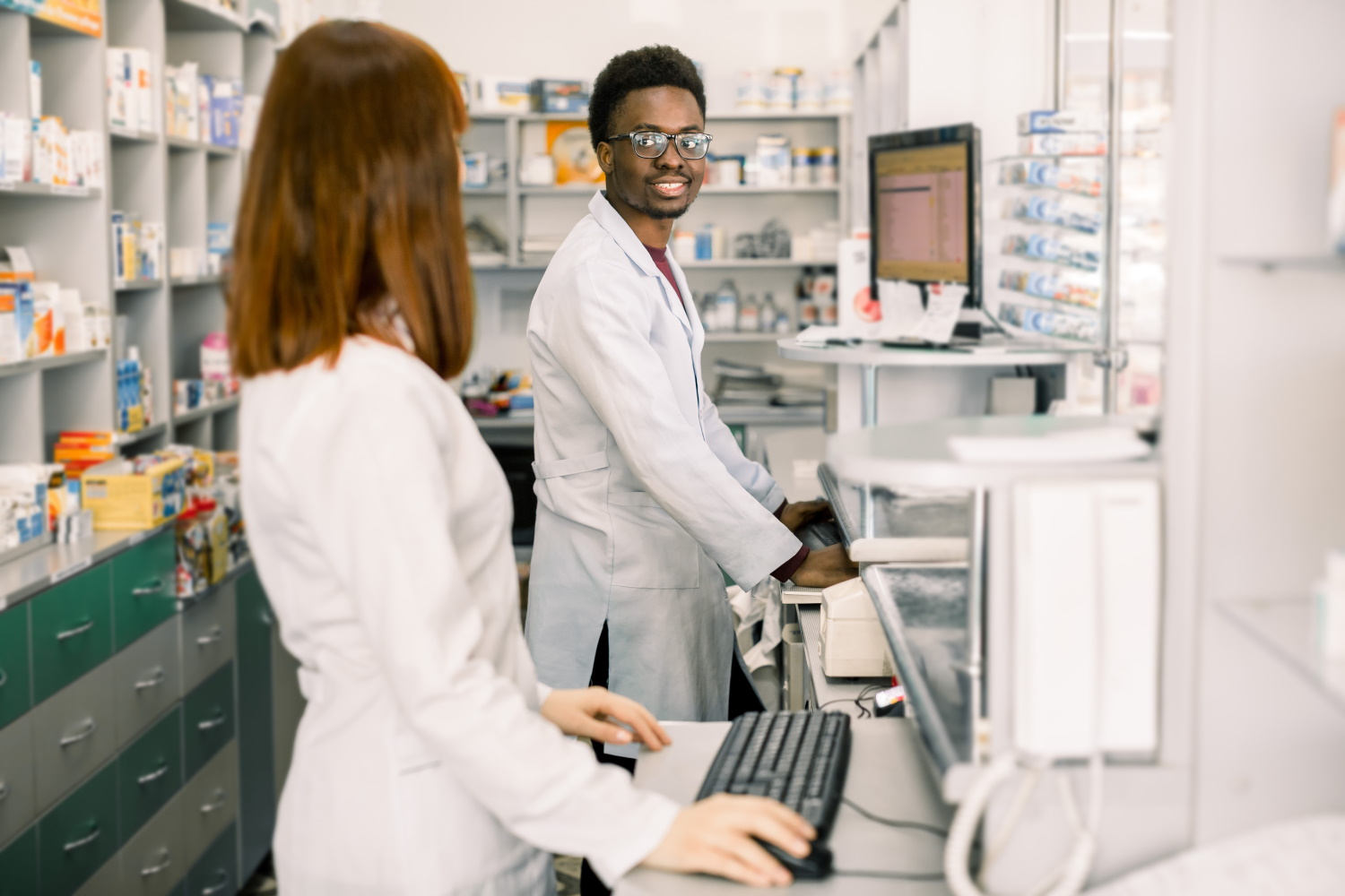 BSPOKE Software - Shows healthcare workers using a custom software system in a pharmacy