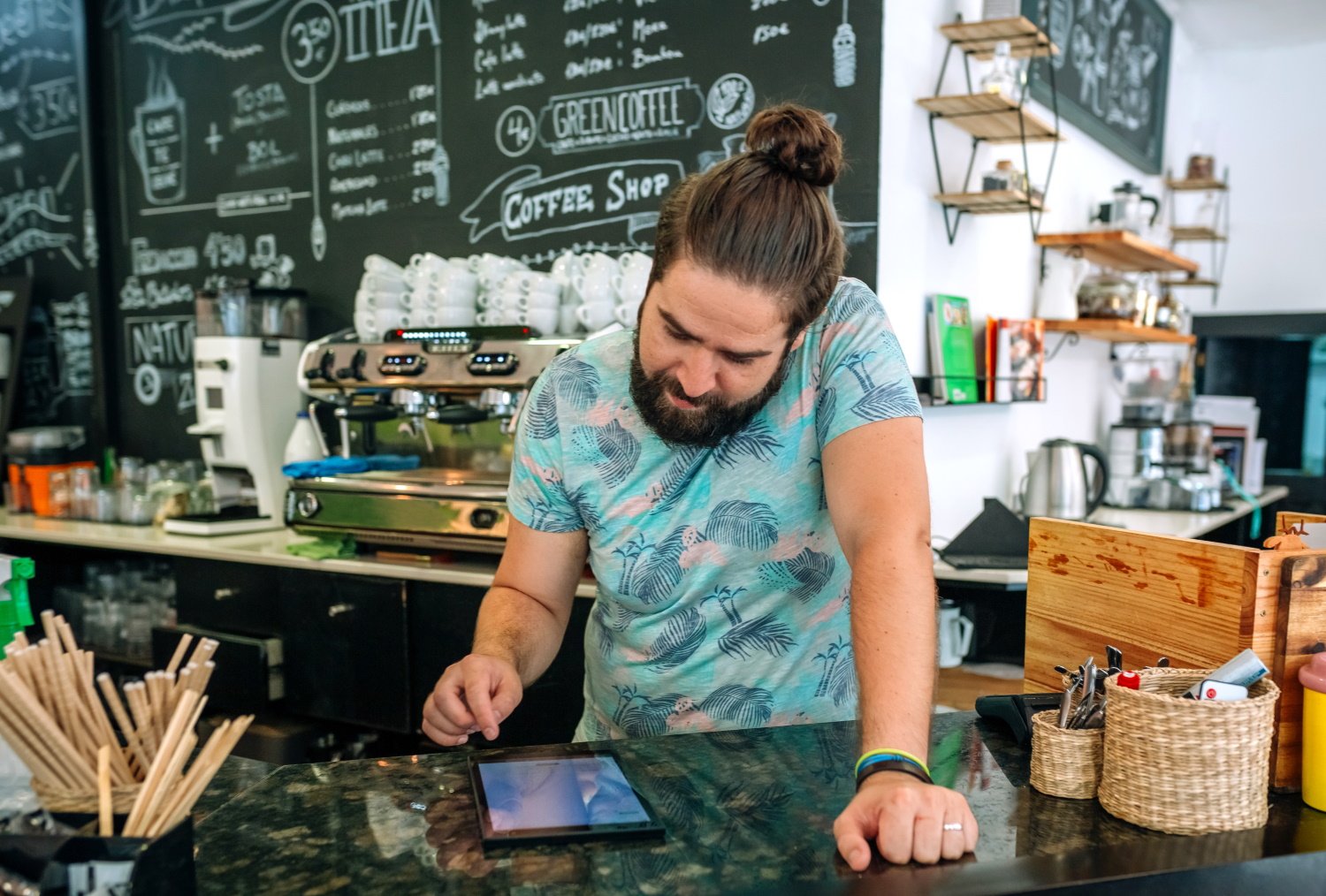 BSPOKE Software - Shows a coffee shop owner using bespoke software for small businesses